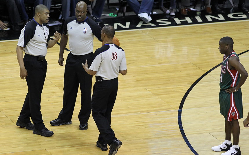 NBA referees on court during a stoppage